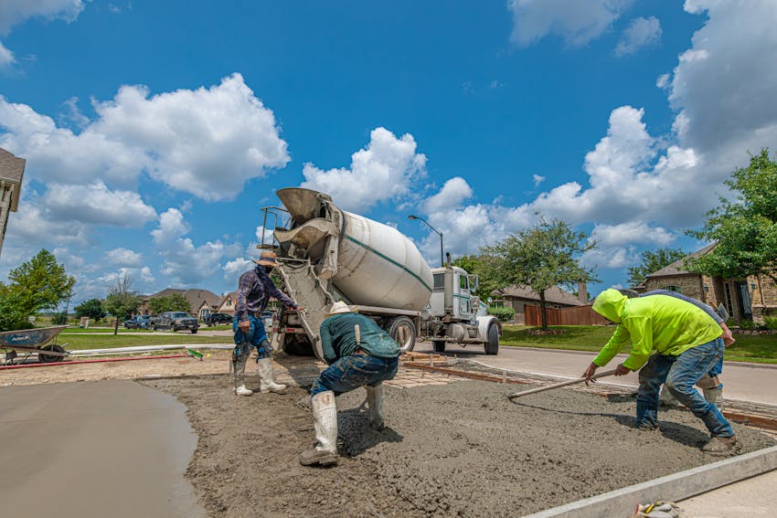Crew pouring and finishing a new concrete driveway in the Central Valley