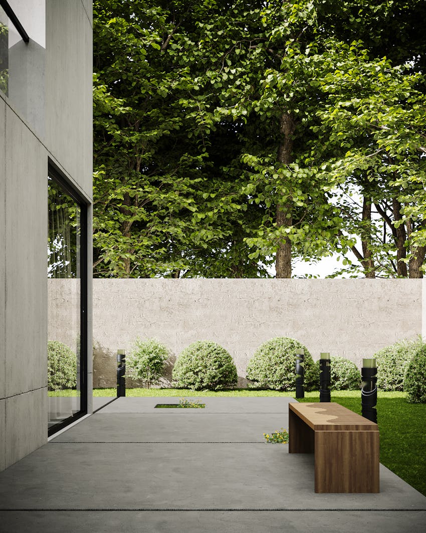 Concrete backyard patio with bench and garden in Clovis