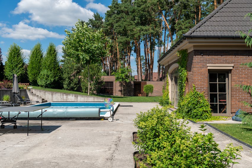 Concrete pool deck around a backyard pool in Fresno